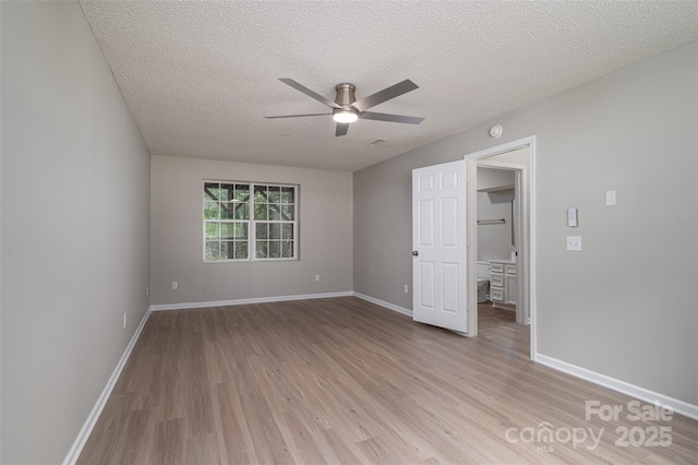 1520 28th St SW, Hickory, NC 28602 - unfurnished bedroom featuring light wood-style floors, baseboards, a textured ceiling, and ceiling fan