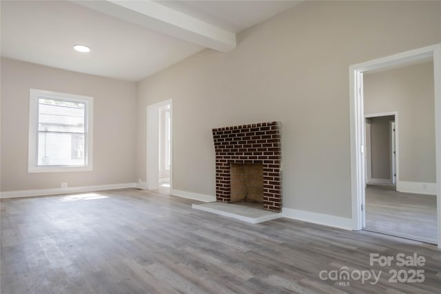 112 Hampton St, Chester, SC 29706 - unfurnished living room featuring wood finished floors, a brick fireplace, baseboards, beam ceiling, and recessed lighting