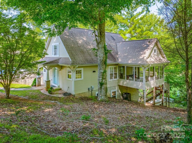 333 Lentz Landing Ln, Nebo, NC 28761 - view of side of property featuring a sunroom, roof with shingles, central AC, and stairway