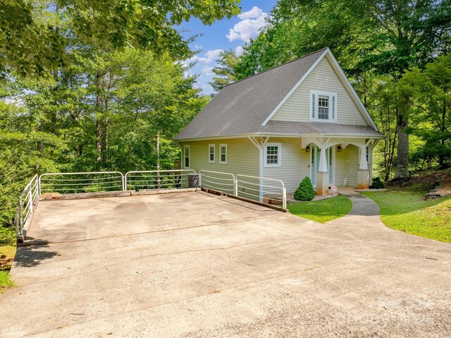 333 Lentz Landing Ln, Nebo, NC 28761 - view of front of property with roof with shingles, a porch, view of wooded area, and driveway