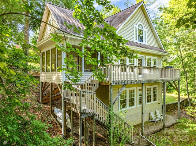 333 Lentz Landing Ln, Nebo, NC 28761 - view of front of home featuring stairway, roof with shingles, a sunroom, and a wooden deck