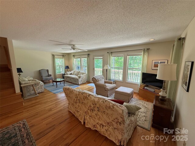 333 Lentz Landing Ln, Nebo, NC 28761 - living room featuring a textured ceiling, wood finished floors, plenty of natural light, and a ceiling fan