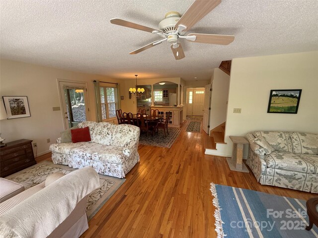 333 Lentz Landing Ln, Nebo, NC 28761 - living room featuring a textured ceiling, a chandelier, ceiling fan, and light wood-style floors
