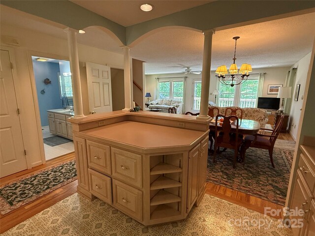 333 Lentz Landing Ln, Nebo, NC 28761 - kitchen with decorative columns, light countertops, open floor plan, open shelves, and arched walkways