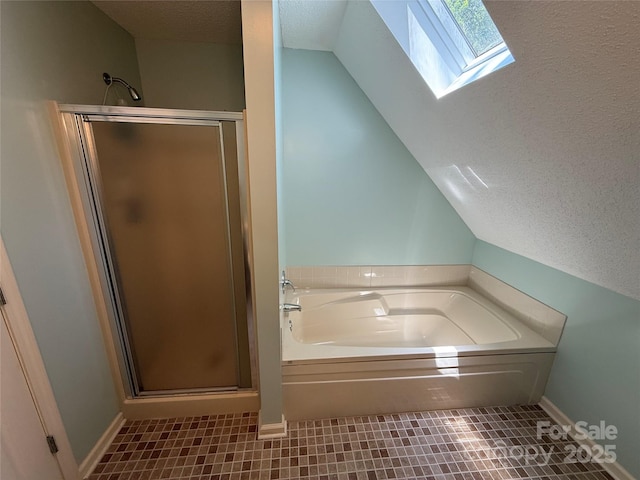 333 Lentz Landing Ln, Nebo, NC 28761 - bathroom with a skylight, a shower stall, a garden tub, a textured ceiling, and vaulted ceiling