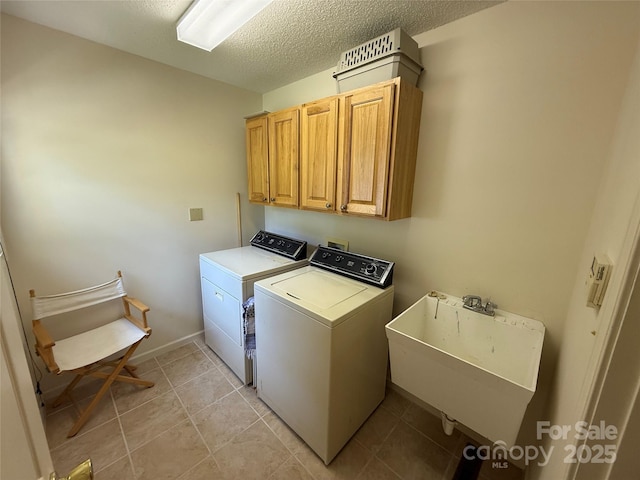 333 Lentz Landing Ln, Nebo, NC 28761 - laundry room featuring washer and dryer, cabinet space, a textured ceiling, and light tile patterned floors