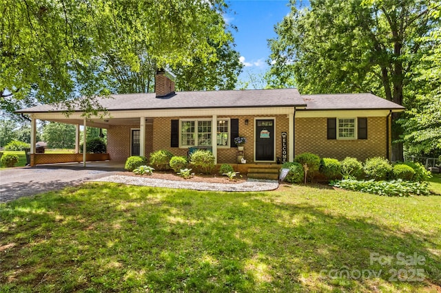 141 Dunlap Loop, Statesville, NC 28625 - single story home featuring a chimney, asphalt driveway, a front yard, an attached carport, and brick siding