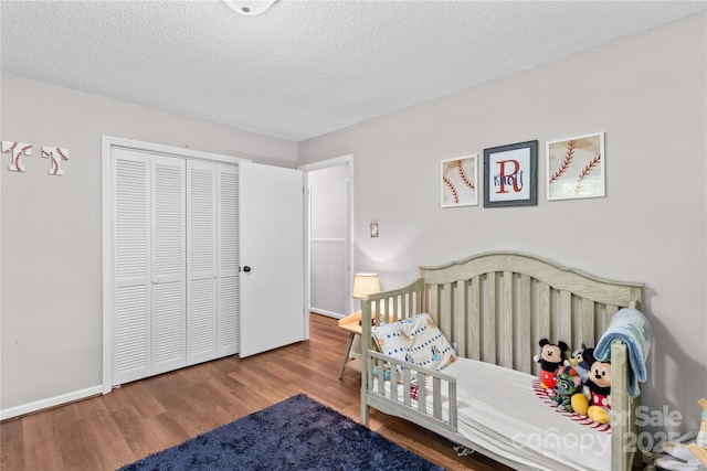 141 Dunlap Loop, Statesville, NC 28625 - bedroom featuring wood finished floors, a closet, a textured ceiling, and baseboards