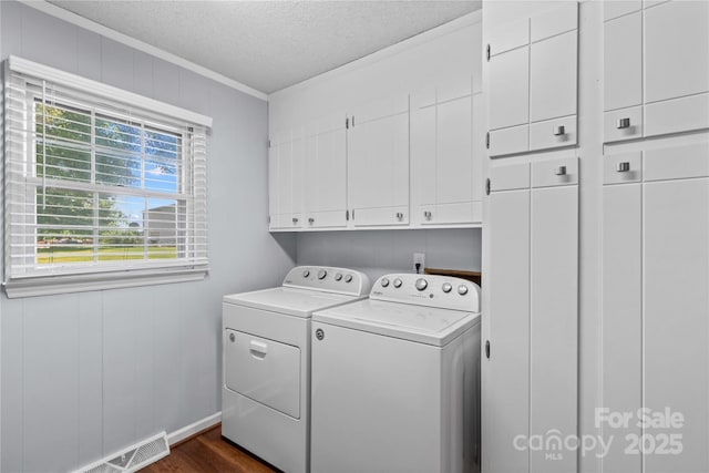 141 Dunlap Loop, Statesville, NC 28625 - laundry room featuring cabinet space, washer and dryer, a textured ceiling, dark wood finished floors, and ornamental molding
