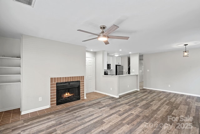 409 W 8th St Unit B, Charlotte, NC 28202 - unfurnished living room with a ceiling fan, wood finished floors, baseboards, a fireplace, and recessed lighting
