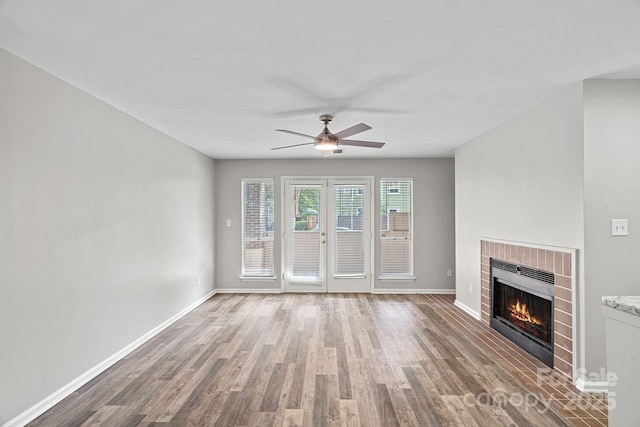 409 W 8th St Unit B, Charlotte, NC 28202 - unfurnished living room with wood finished floors, ceiling fan, a fireplace, and baseboards