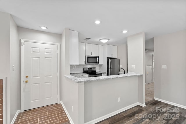 409 W 8th St Unit B, Charlotte, NC 28202 - kitchen with stainless steel appliances, white cabinetry, baseboards, light stone counters, and recessed lighting