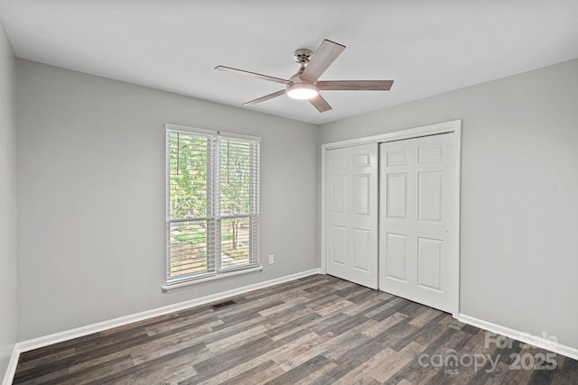 409 W 8th St Unit B, Charlotte, NC 28202 - unfurnished bedroom featuring dark wood-type flooring, a closet, baseboards, and ceiling fan