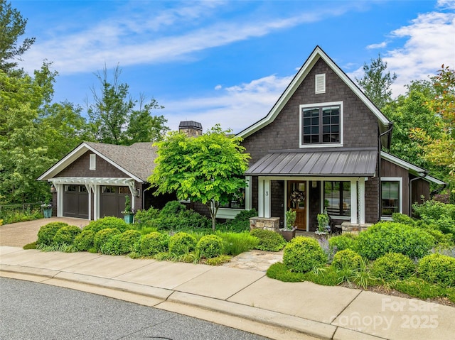 3 Bayonne Trl, Asheville, NC 28804 - craftsman house featuring covered porch, a standing seam roof, a chimney, concrete driveway, and an attached garage