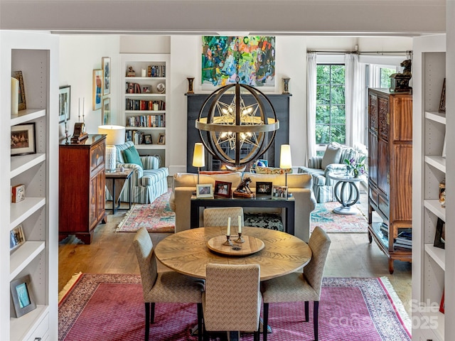 3 Bayonne Trl, Asheville, NC 28804 - dining space with wood finished floors, built in shelves, and a chandelier