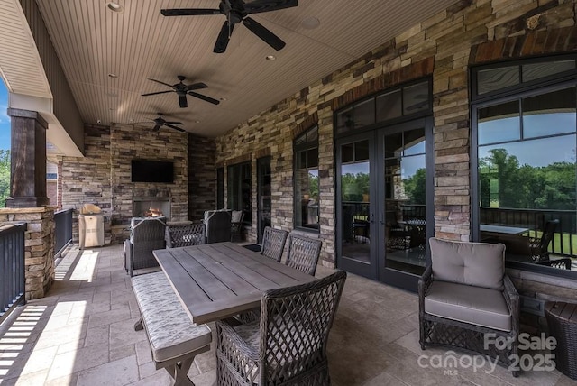 109 Oak Forest Dr, Kings Mountain, NC 28086 - view of patio with an outdoor stone fireplace, french doors, a ceiling fan, and outdoor dining space