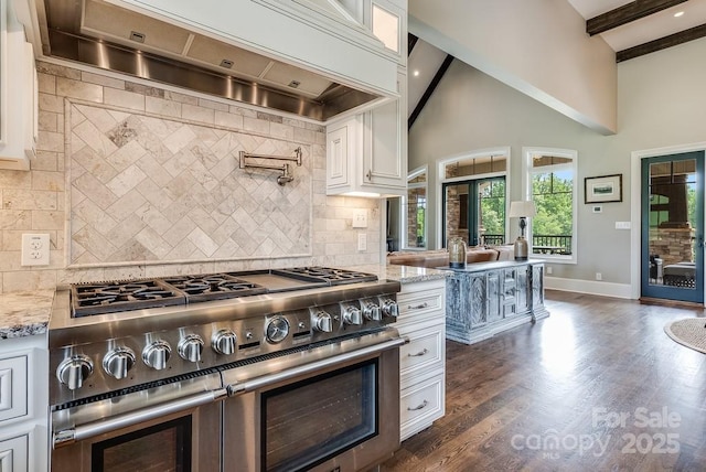 109 Oak Forest Dr, Kings Mountain, NC 28086 - kitchen with range with two ovens, custom range hood, light stone counters, decorative backsplash, and white cabinetry