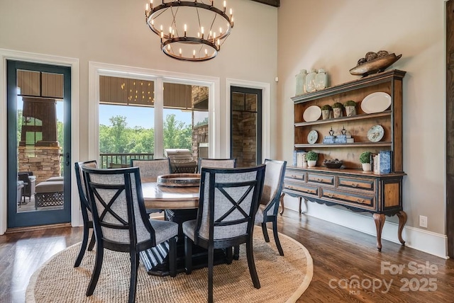109 Oak Forest Dr, Kings Mountain, NC 28086 - dining area featuring a chandelier, dark wood-type flooring, and a high ceiling