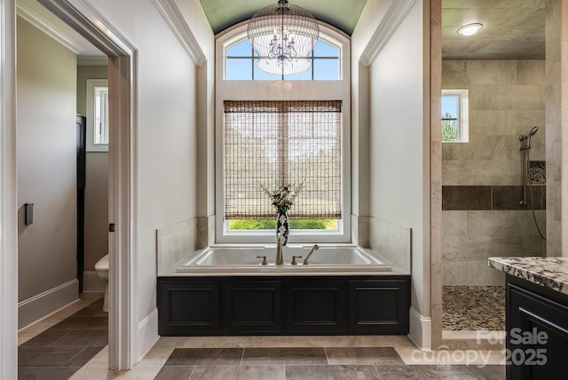 109 Oak Forest Dr, Kings Mountain, NC 28086 - bathroom featuring a garden tub, a chandelier, baseboards, a walk in shower, and toilet