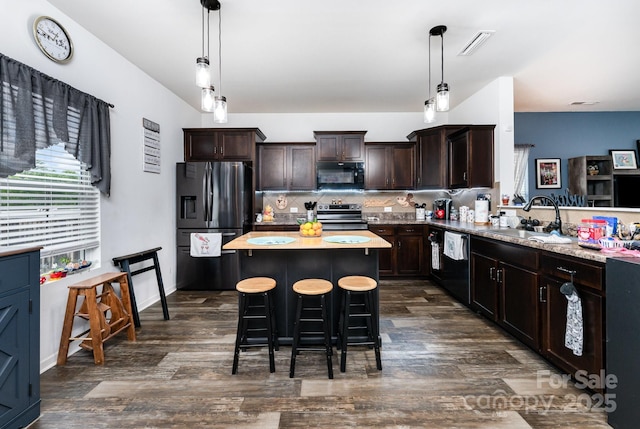 189 Fesperman Cir, Troutman, NC 28166 - kitchen with black appliances, a sink, dark brown cabinetry, light countertops, and dark wood finished floors
