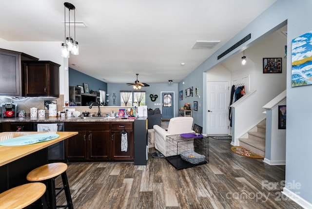 189 Fesperman Cir, Troutman, NC 28166 - kitchen featuring dark wood-style flooring, a sink, a peninsula, and dark brown cabinets