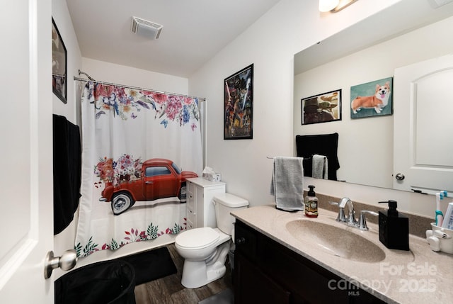 189 Fesperman Cir, Troutman, NC 28166 - full bathroom featuring vanity, toilet, shower / bath combo with shower curtain, and wood finished floors