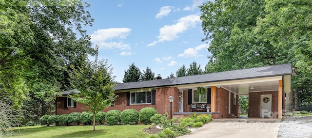 240 China Grove Rd, China Grove, NC 28123 - ranch-style home featuring driveway, brick siding, an attached carport, a front yard, and a porch