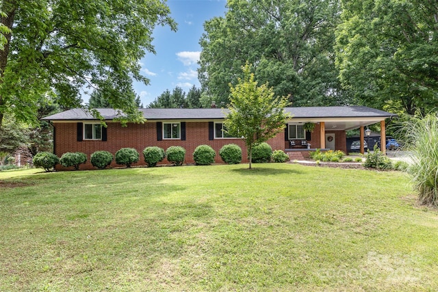 240 China Grove Rd, China Grove, NC 28123 - ranch-style house featuring brick siding, a front yard, and a carport