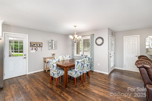 240 China Grove Rd, China Grove, NC 28123 - dining room featuring a chandelier, baseboards, and wood finished floors