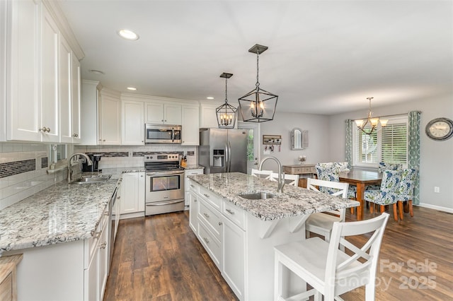 240 China Grove Rd, China Grove, NC 28123 - kitchen with stainless steel appliances, a sink, a chandelier, decorative backsplash, and recessed lighting