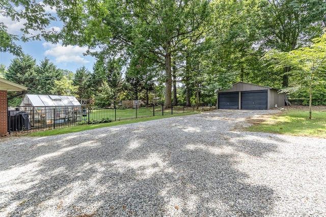 240 China Grove Rd, China Grove, NC 28123 - view of yard featuring an outdoor structure, an exterior structure, a garage, and view of wooded area