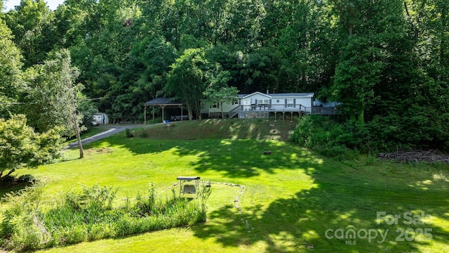 5366 Hayes Waters Rd, Morganton, NC 28655 - view of green lawn featuring a deck and a wooded view