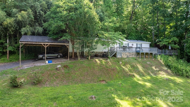 5366 Hayes Waters Rd, Morganton, NC 28655 - view of green lawn with a deck, a detached carport, a forest view, and stairway