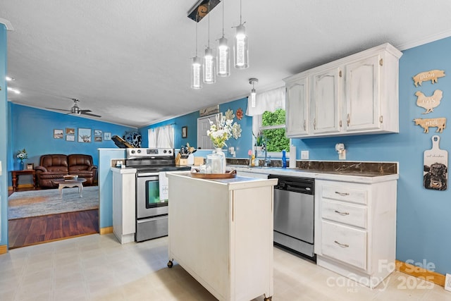 5366 Hayes Waters Rd, Morganton, NC 28655 - kitchen with appliances with stainless steel finishes, white cabinets, a ceiling fan, hanging light fixtures, and a center island
