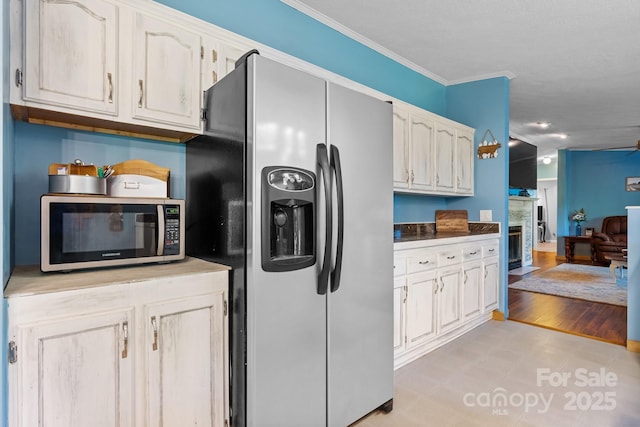 5366 Hayes Waters Rd, Morganton, NC 28655 - kitchen with refrigerator with ice dispenser, stainless steel microwave, crown molding, and light floors