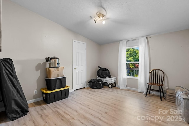 5366 Hayes Waters Rd, Morganton, NC 28655 - miscellaneous room with lofted ceiling, light wood-style flooring, baseboards, and a textured ceiling