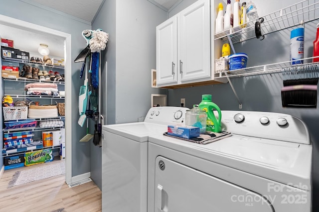 5366 Hayes Waters Rd, Morganton, NC 28655 - laundry room with washing machine and dryer, cabinet space, and light wood-style flooring