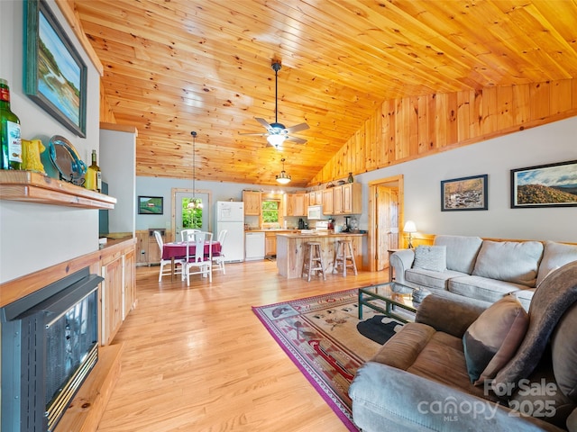 198 Bear Ridge Rd, Bakersville, NC 28705 - living area with wooden ceiling, light wood finished floors, ceiling fan, a wood stove, and high vaulted ceiling