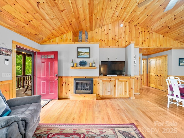 198 Bear Ridge Rd, Bakersville, NC 28705 - living room with lofted ceiling, wood finished floors, wood ceiling, a glass covered fireplace, and wooden walls