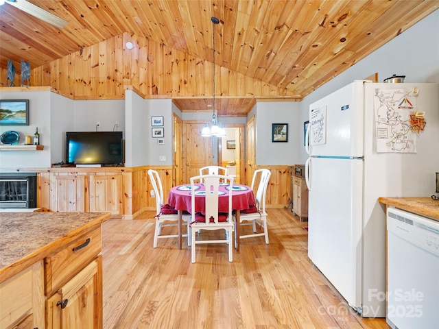 198 Bear Ridge Rd, Bakersville, NC 28705 - dining space featuring lofted ceiling, light wood finished floors, wooden ceiling, wainscoting, and wood walls