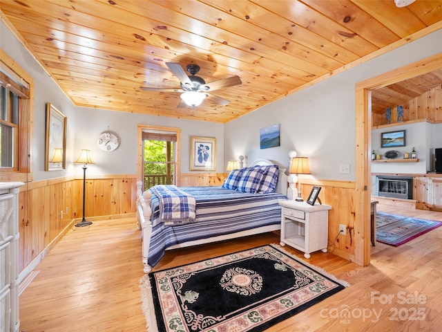 198 Bear Ridge Rd, Bakersville, NC 28705 - bedroom featuring wainscoting, wood ceiling, wooden walls, wood finished floors, and access to outside