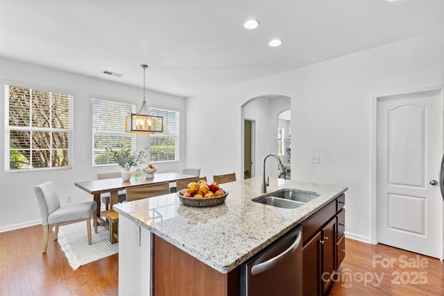 10027 Juniper Trace Dr, Charlotte, NC 28277 - kitchen with a sink, stainless steel dishwasher, arched walkways, light wood finished floors, and recessed lighting
