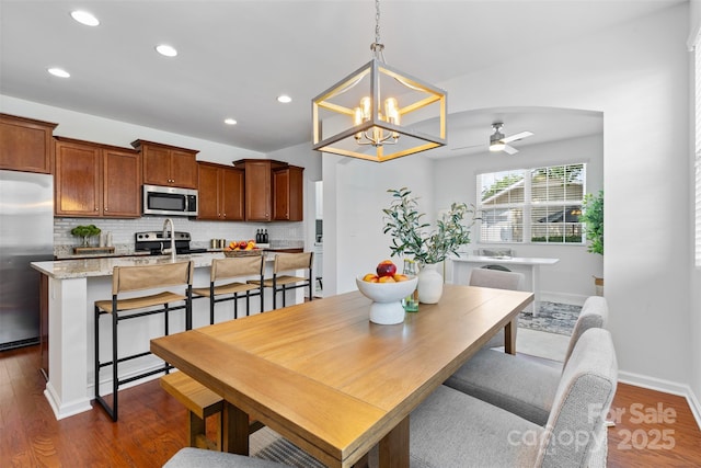 10027 Juniper Trace Dr, Charlotte, NC 28277 - dining room with ceiling fan, dark wood-style flooring, recessed lighting, a chandelier, and baseboards