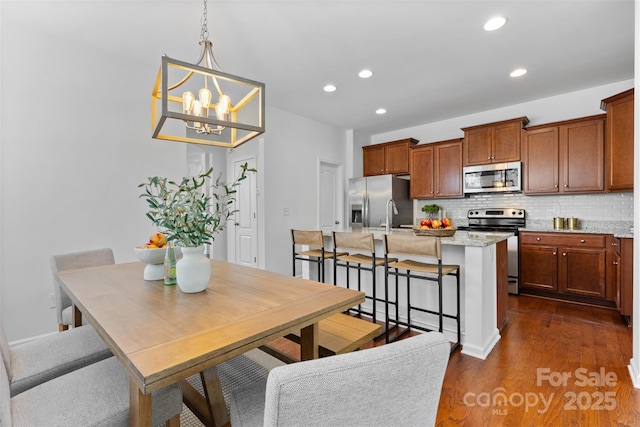 10027 Juniper Trace Dr, Charlotte, NC 28277 - dining room with dark wood-style floors, recessed lighting, and a chandelier