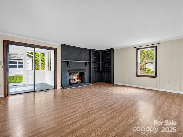 3016 US-176 Hwy, Tryon, NC 28782 - unfurnished living room featuring wood finished floors, baseboards, a fireplace, and crown molding