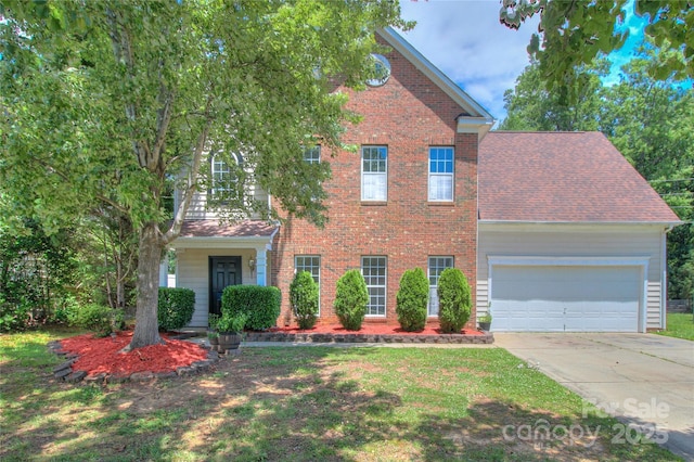 6310 Trevor Simpson Dr, Indian Trail, NC 28079 - traditional home with driveway, an attached garage, brick siding, and a front yard