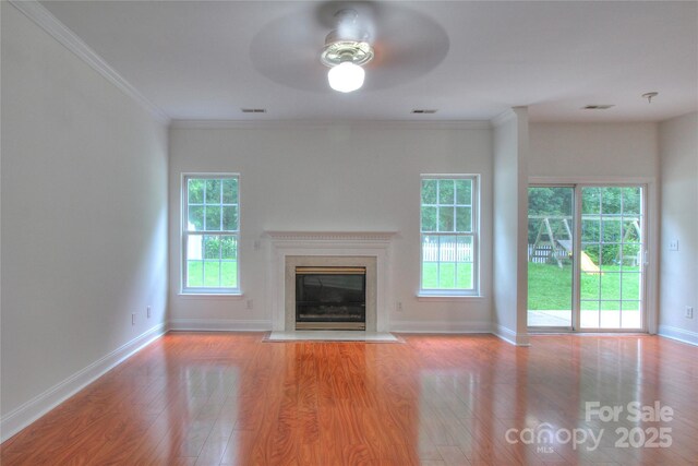 6310 Trevor Simpson Dr, Indian Trail, NC 28079 - unfurnished living room featuring ceiling fan, wood finished floors, plenty of natural light, and crown molding