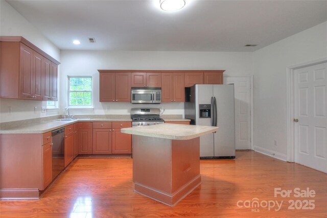 6310 Trevor Simpson Dr, Indian Trail, NC 28079 - kitchen featuring appliances with stainless steel finishes, light wood-style flooring, light countertops, a sink, and recessed lighting