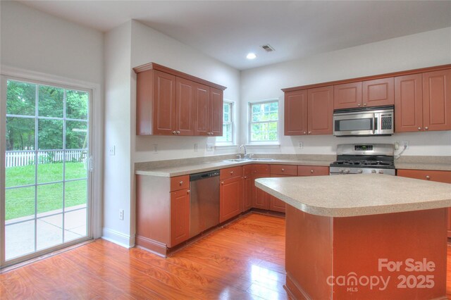 6310 Trevor Simpson Dr, Indian Trail, NC 28079 - kitchen with stainless steel appliances, light countertops, light wood-style floors, a sink, and recessed lighting
