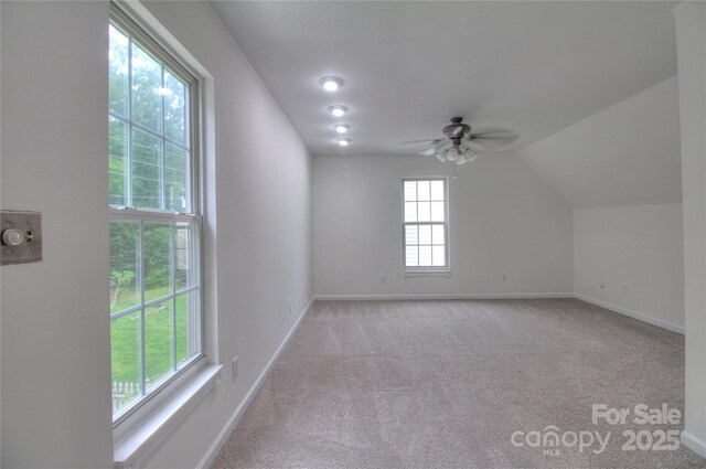 6310 Trevor Simpson Dr, Indian Trail, NC 28079 - additional living space with light colored carpet, ceiling fan, baseboards, and vaulted ceiling